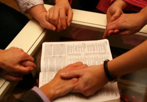 holding hands in prayer